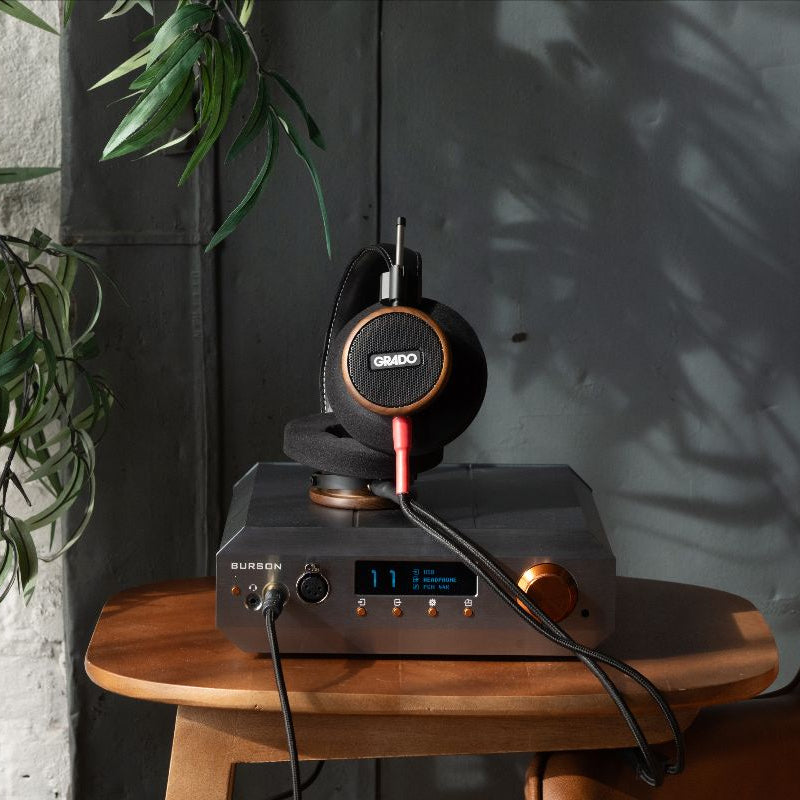 Wired Grado Signature S550 headphones with sleek design and metal ear cups, shown resting on a surface.