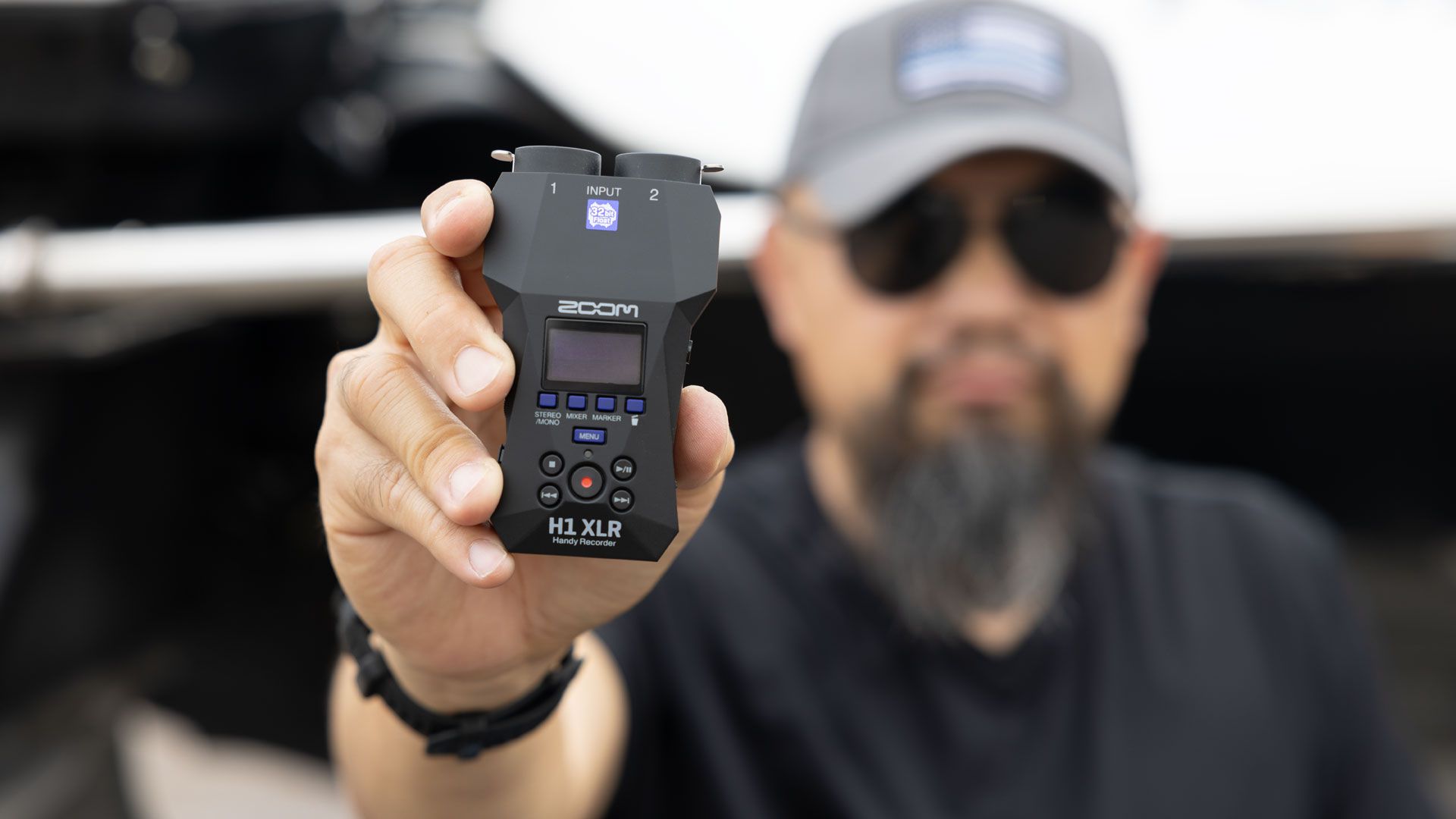 Zoom H1 XLR digital recorder with XLR input, compact design, and multiple recording features visible in the image.