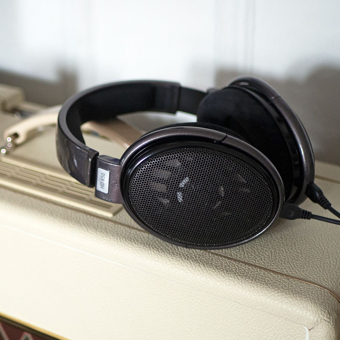 Sennheiser HD 650 studio headphones with open-back design and plush ear cushions, displaying the high-quality audio equipment.