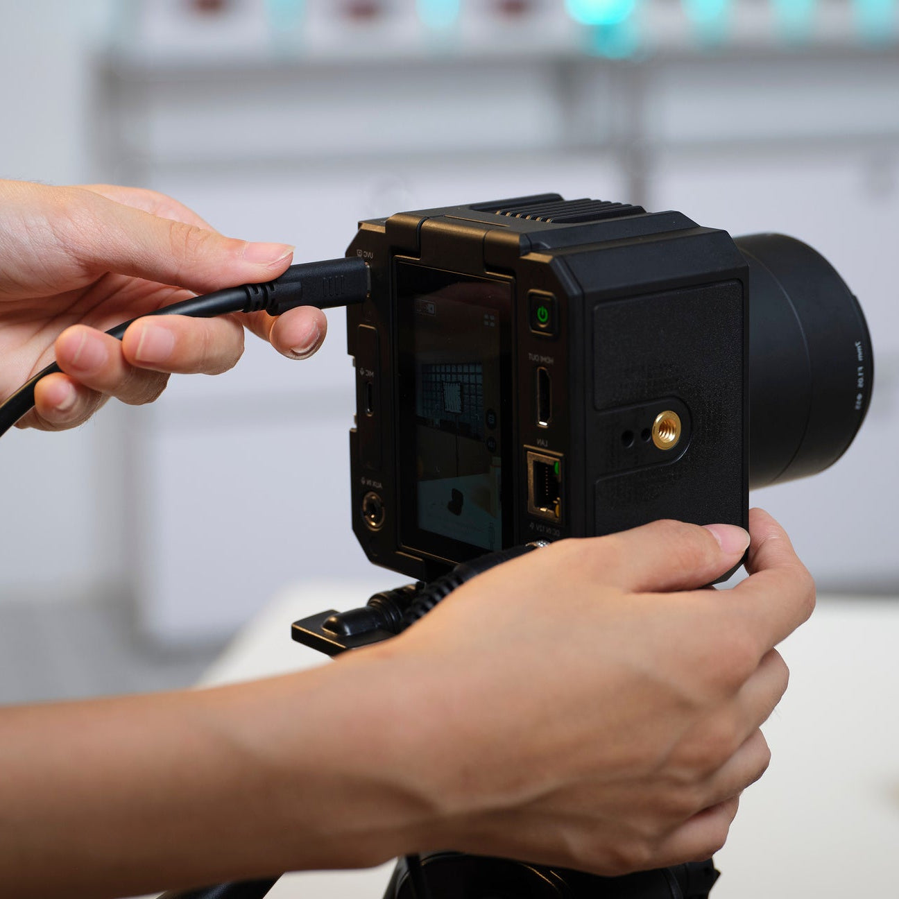 Hollyland VenusLiv Air 24/7 Live Streaming Camera for video conferencing, showing the sleek black device with lens and controls.