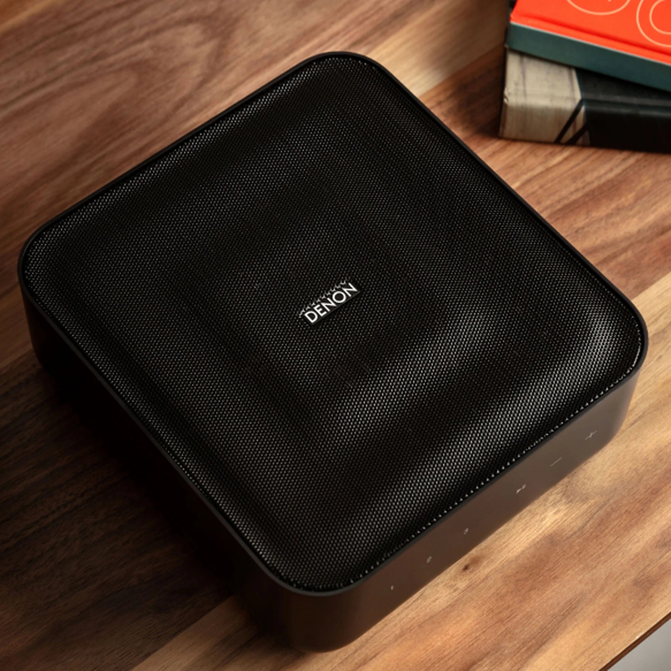 Denon Home Amp stereo amplifier with sleek design, multiple controls, and connections for high-quality audio.