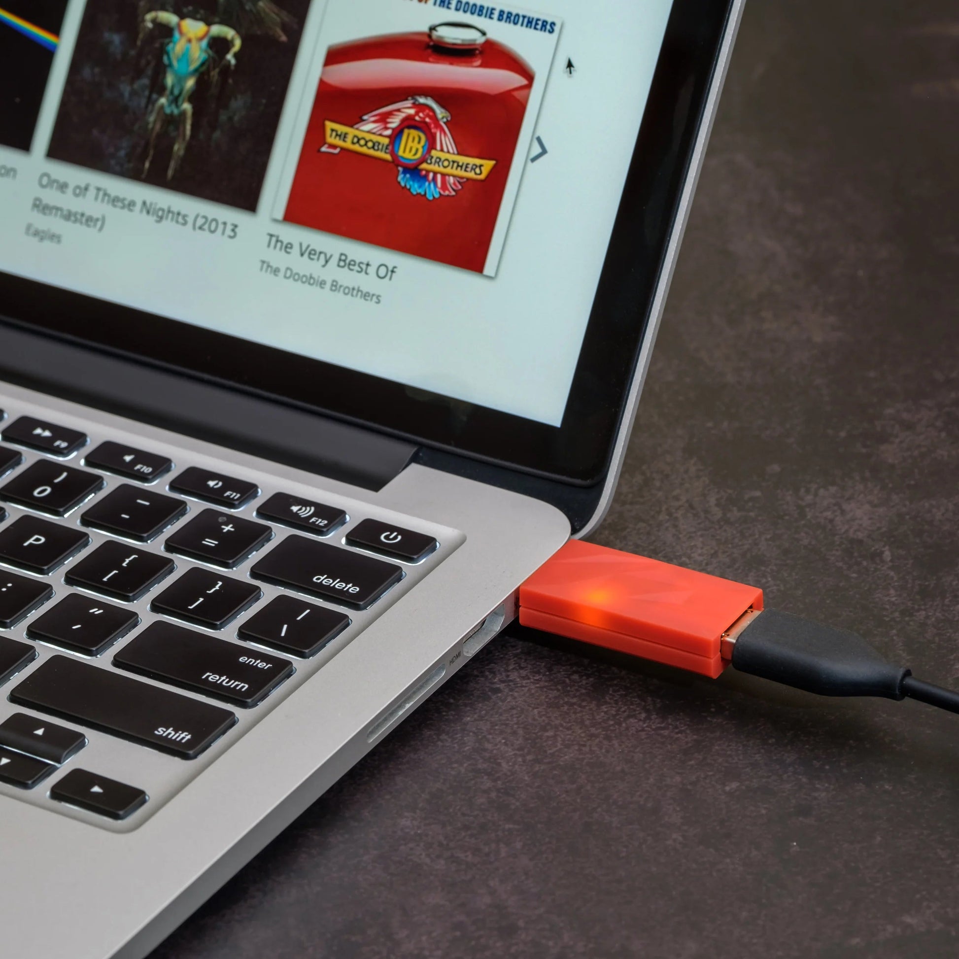 SilentPower iDefender+ noise filter and conditioner on a desk with electronic devices, showcasing its sleek design.