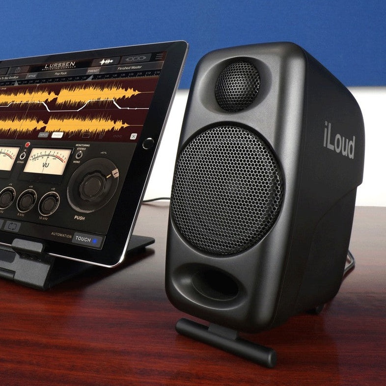 IK Multimedia iLoud Micro Monitors desktop speakers shown on a desk, featuring compact design and professional audio quality.