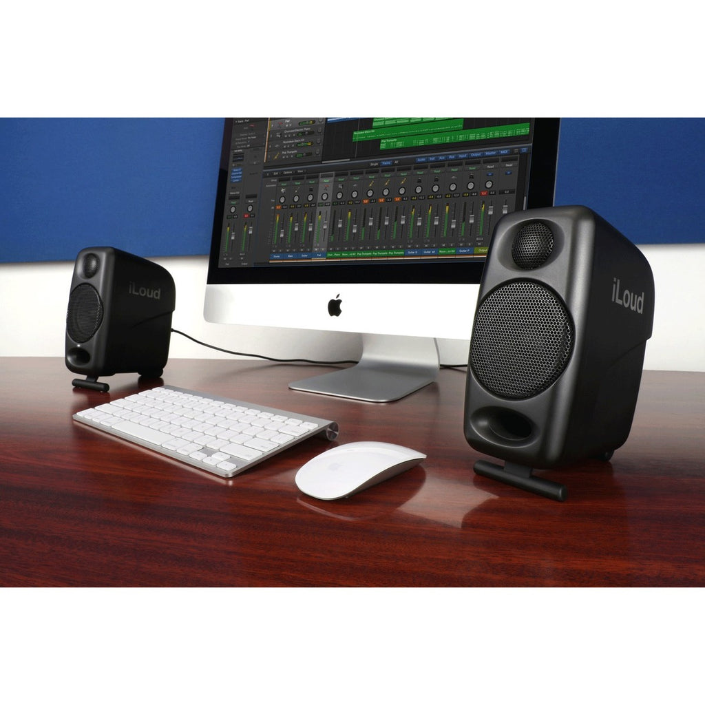 IK Multimedia iLoud Micro Monitors desktop speakers shown on a desk, compact professional audio monitors for accurate sound.