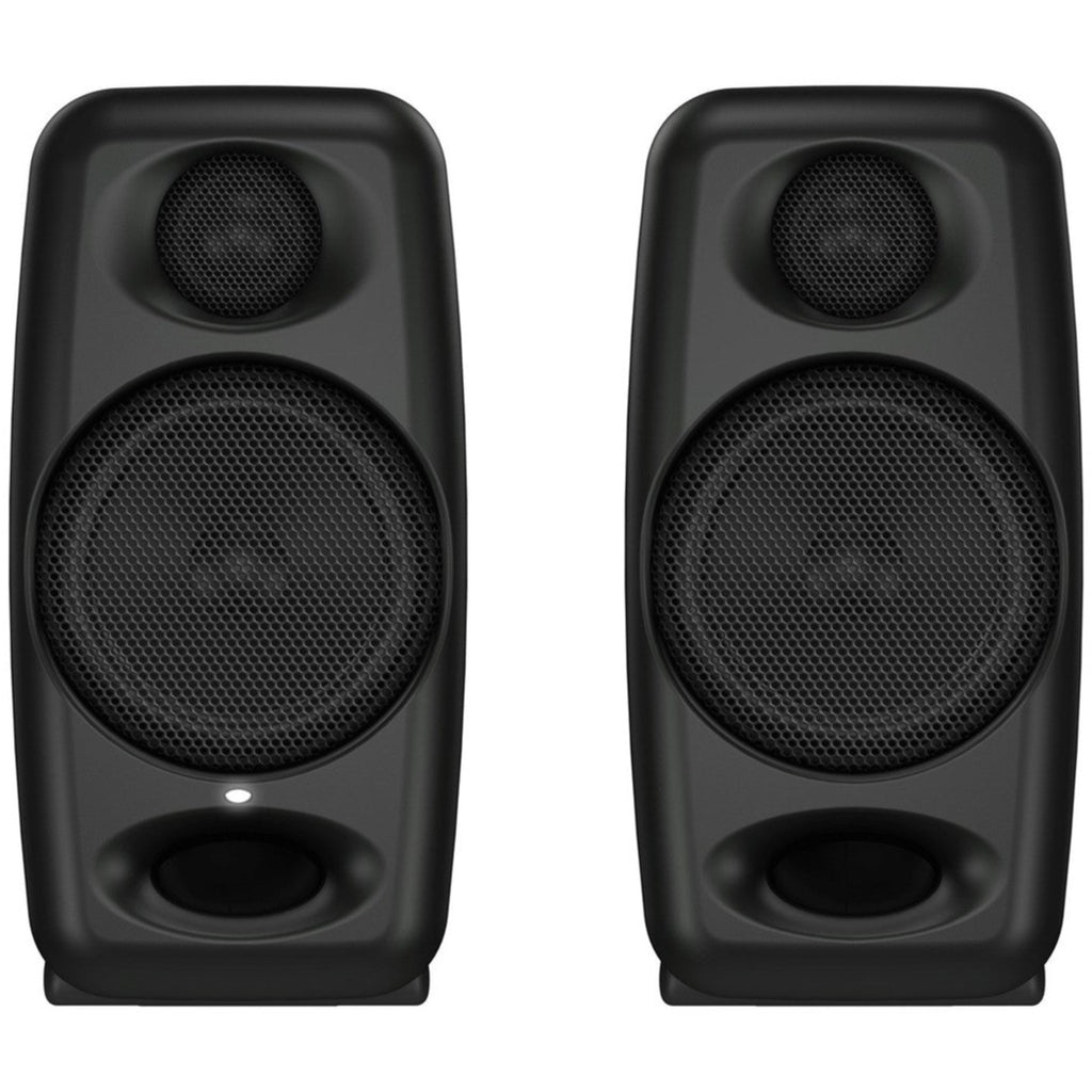 IK Multimedia iLoud Micro Monitors desktop speakers on a desk, showcasing compact, high-quality audio speakers for professional sound.