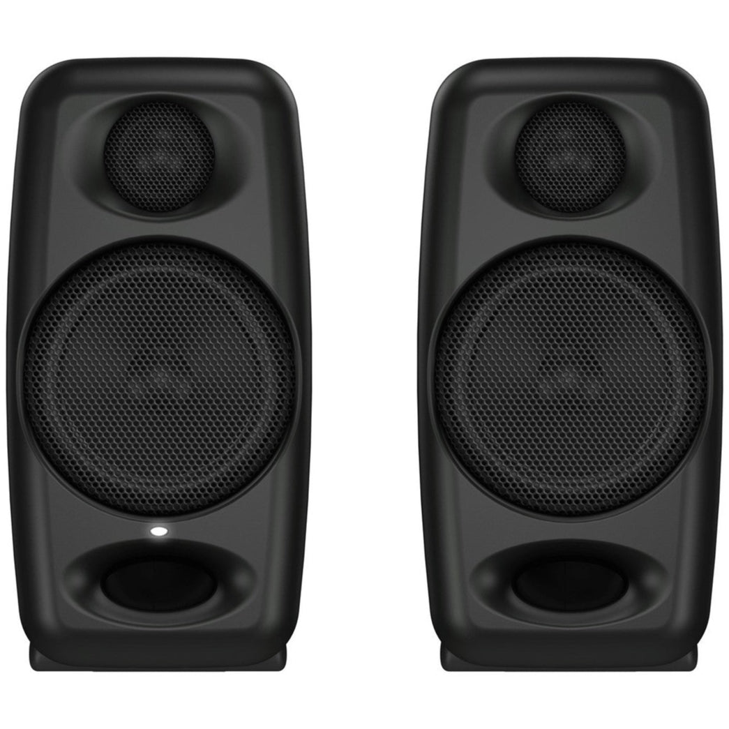 IK Multimedia iLoud Micro Monitors desktop speakers on a desk, showcasing compact, high-quality audio speakers for professional sound.