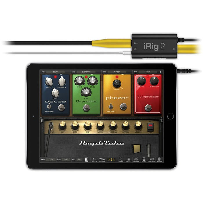 IK Multimedia iRig 2 audio interface connected to a smartphone, showing input and output ports on a compact device.