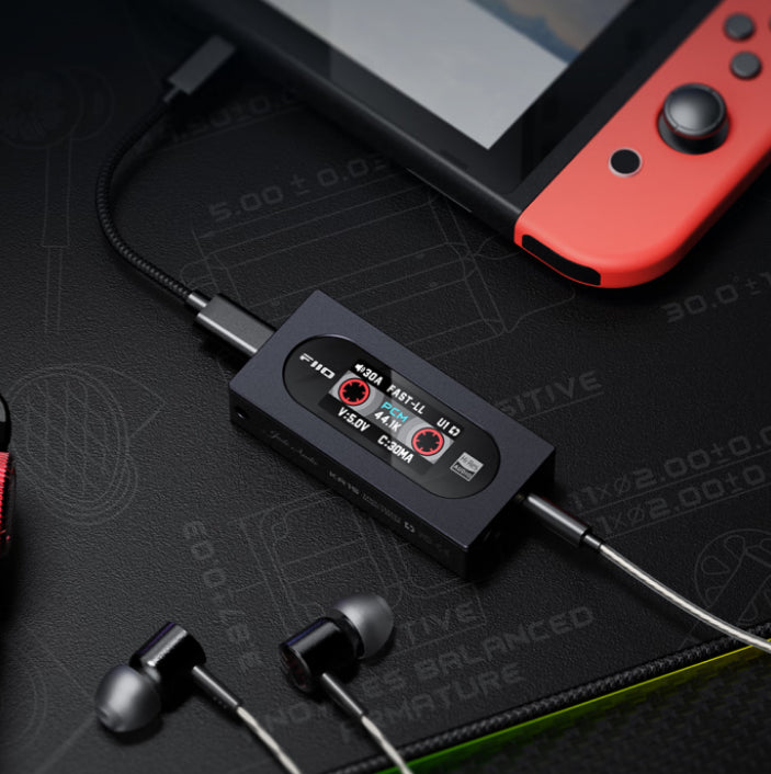 FiiO KA15 headphone amplifier and DAC with sleek black design and visible controls and input ports on the front panel.