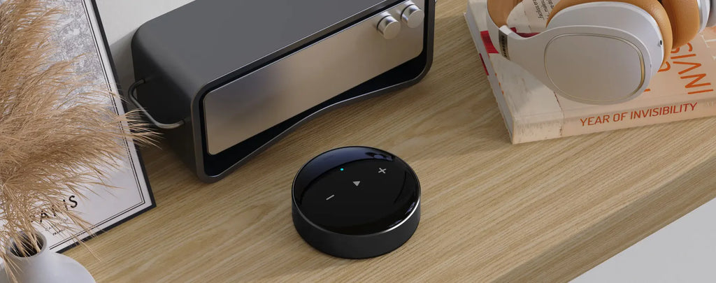 WiiM Mini music streamer device with front and side view, featuring control buttons and connectivity ports.
