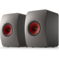 KEF LS50 Meta passive bookshelf speakers with sleek black cabinets and gold accents, designed for high-quality audio.