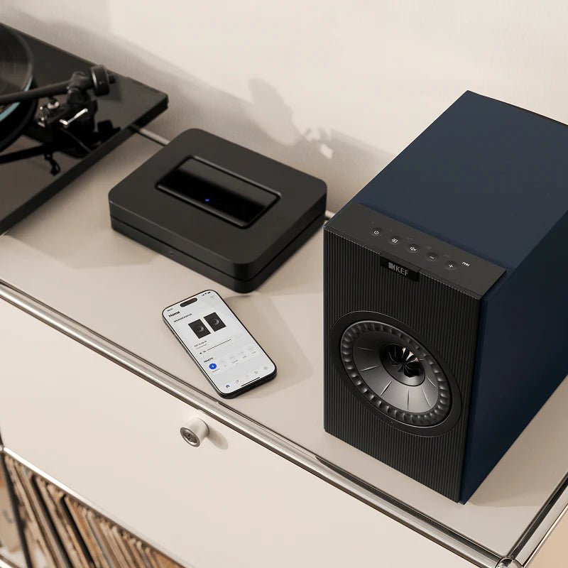 KEF Coda W active bookshelf speakers with sleek black finish and compact design, featuring detailed speaker drivers and modern aesthetic.