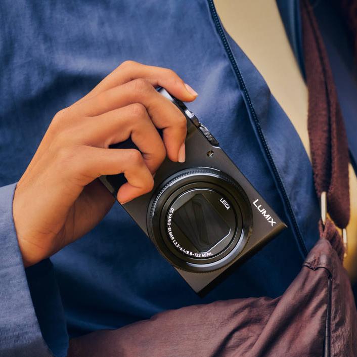 Panasonic LUMIX TZ300 compact camera with lens extended, showing front view and textured grip for easy handling.