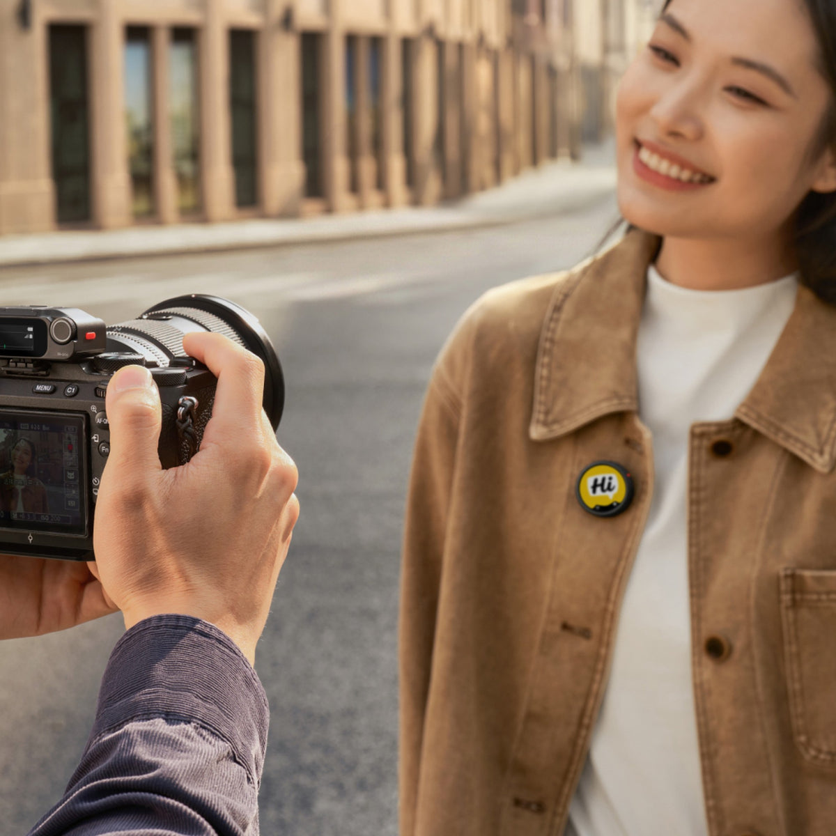 Insta360 Mic Pro transmitter worn on a jacket during a street shoot with a camera