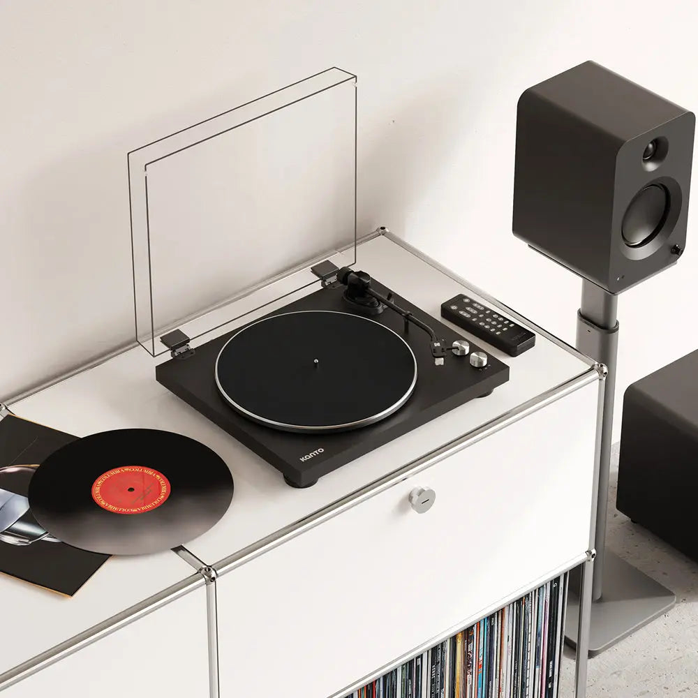 Kanto Audio OBI3 turntable with sleek black finish, featuring tonearm, platter, and control buttons on a modern audio setup.