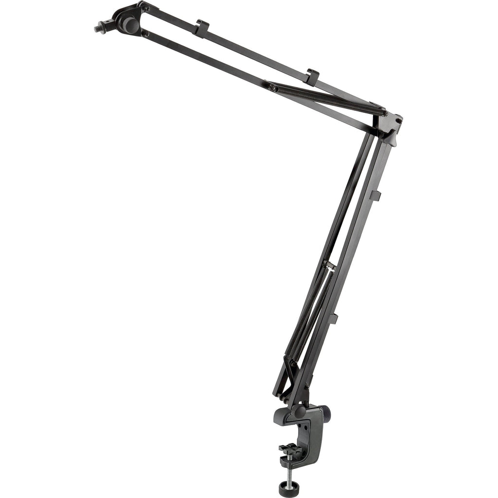K&M 23840 broadcast microphone desk arm mounted on a desk with adjustable joints for professional studio use