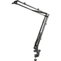 K&M 23840 broadcast microphone desk arm mounted on a desk with adjustable joints for professional studio use