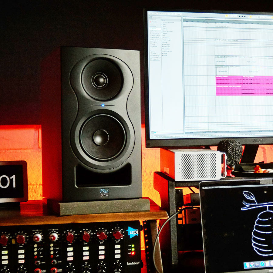 Kali Audio IN-5 studio monitor with a black finish and front-facing bass port, showcasing a sleek design and professional features.