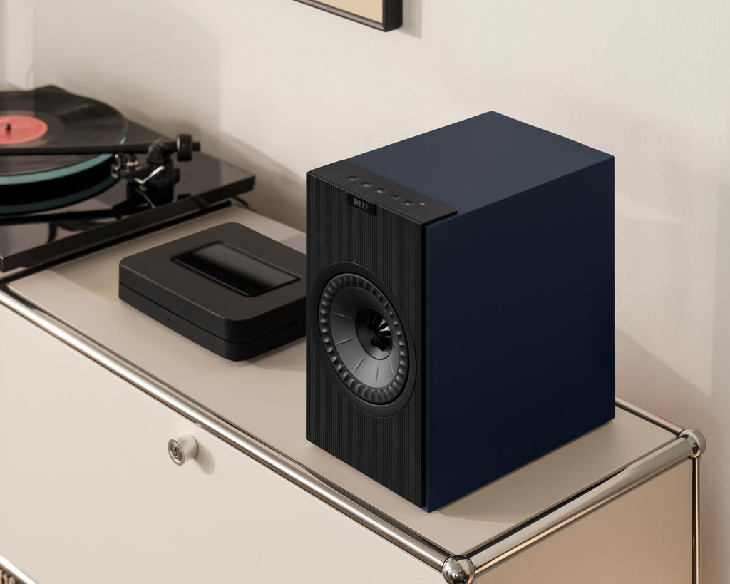 Black KEF Coda W active bookshelf speakers with sleek design and KEF logo, shown from a front angle.