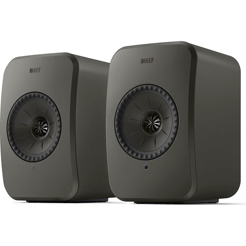 KEF LSX II LT active bookshelf speakers shown in a modern living room setup with sleek black design.