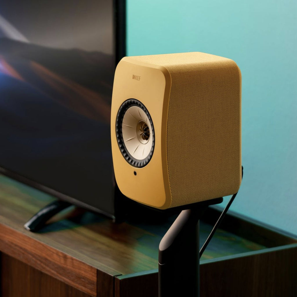 Pair of KEF LSX II wireless active bookshelf speakers in Amber Haze finish, showing sleek modern design and compact form.