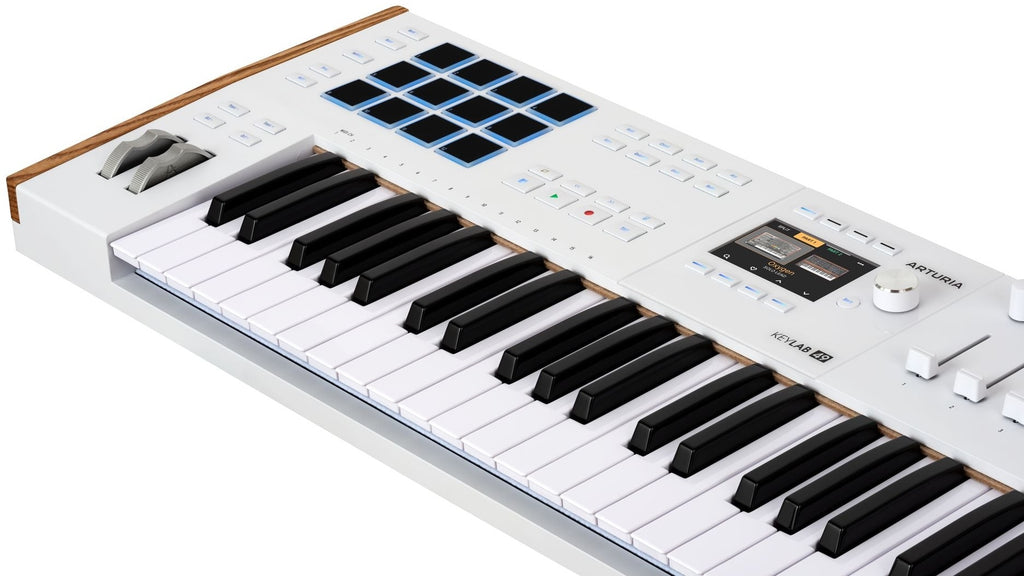 Arturia KeyLab 49 MK3 MIDI keyboard with black keys, featuring control knobs and pads, shown from a side angle.