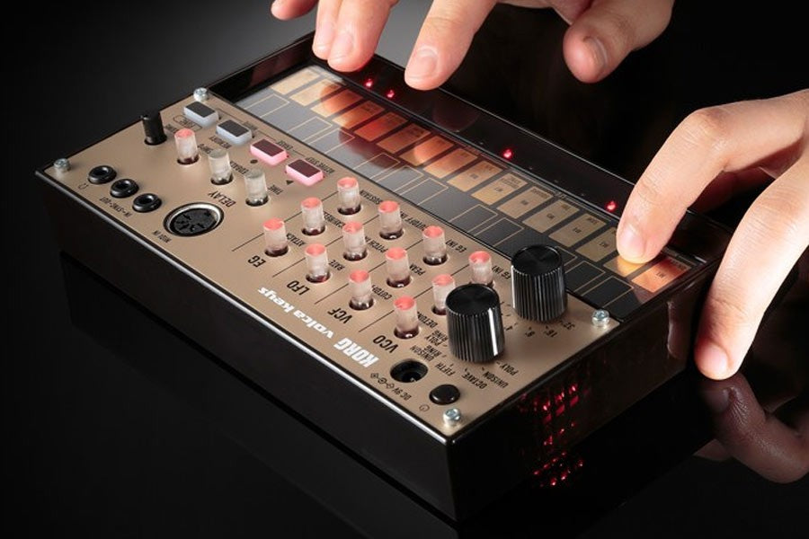 Korg Volca Keys synthesizer in use, showing its compact design and control knobs for creating electronic music.
