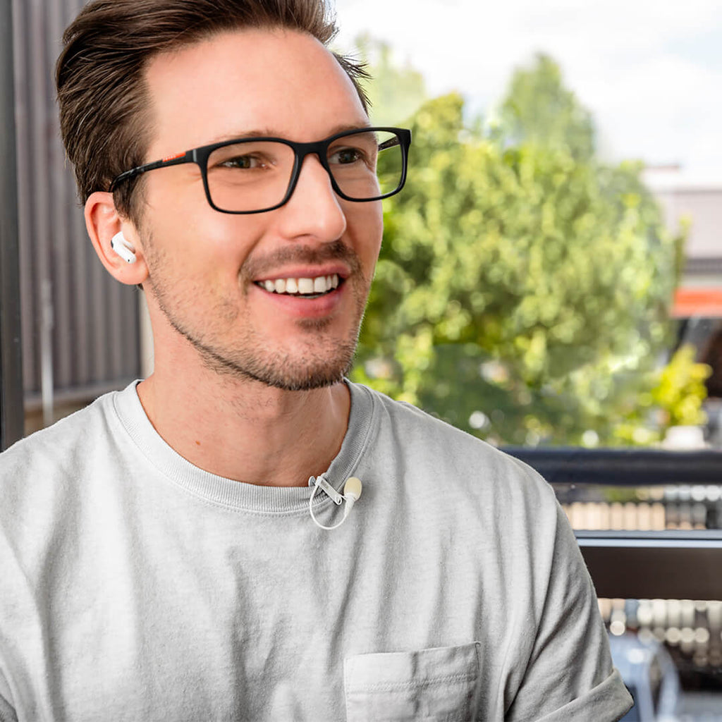 Rode Lavalier GO microphone clipped to a clothing collar, compact and discreet wearable microphone for professional audio recording.