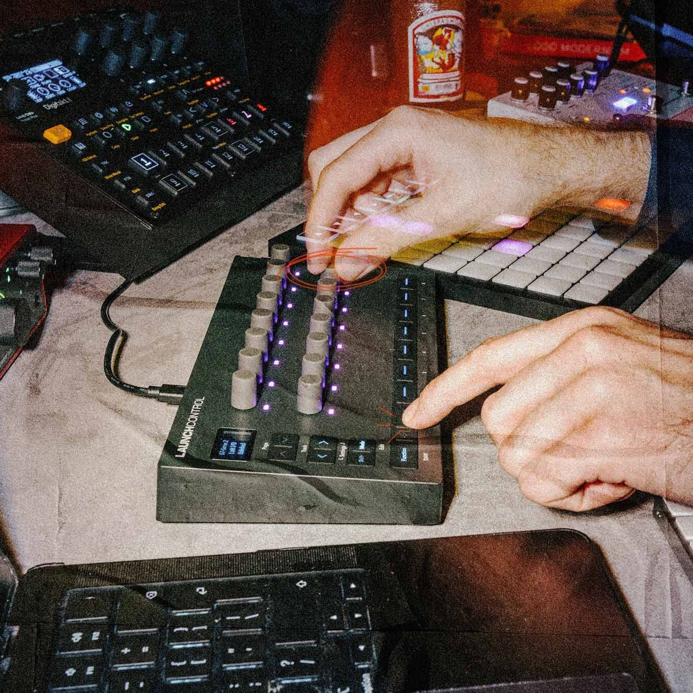 Novation Launch Control 3 MIDI controller with customizable knobs and buttons in a studio setting.