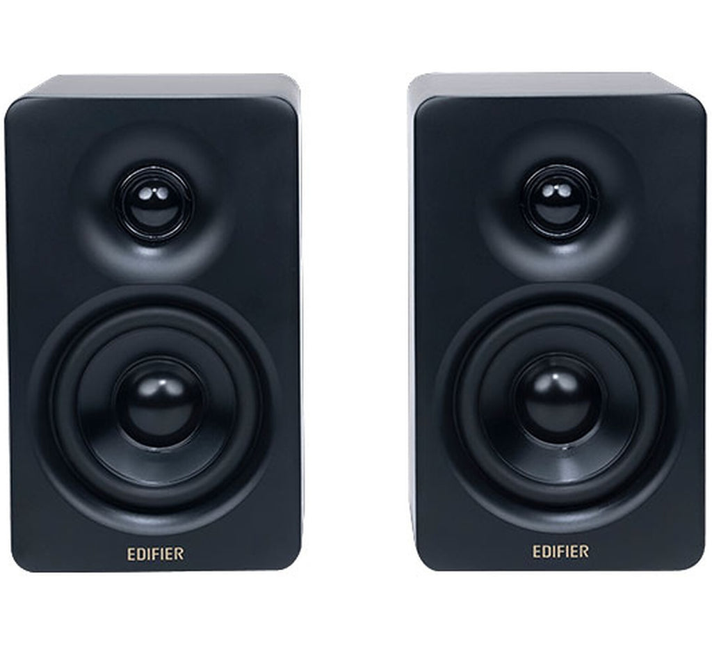 Edifier M60 desktop speakers with sleek black design and control knobs on a wooden desk.