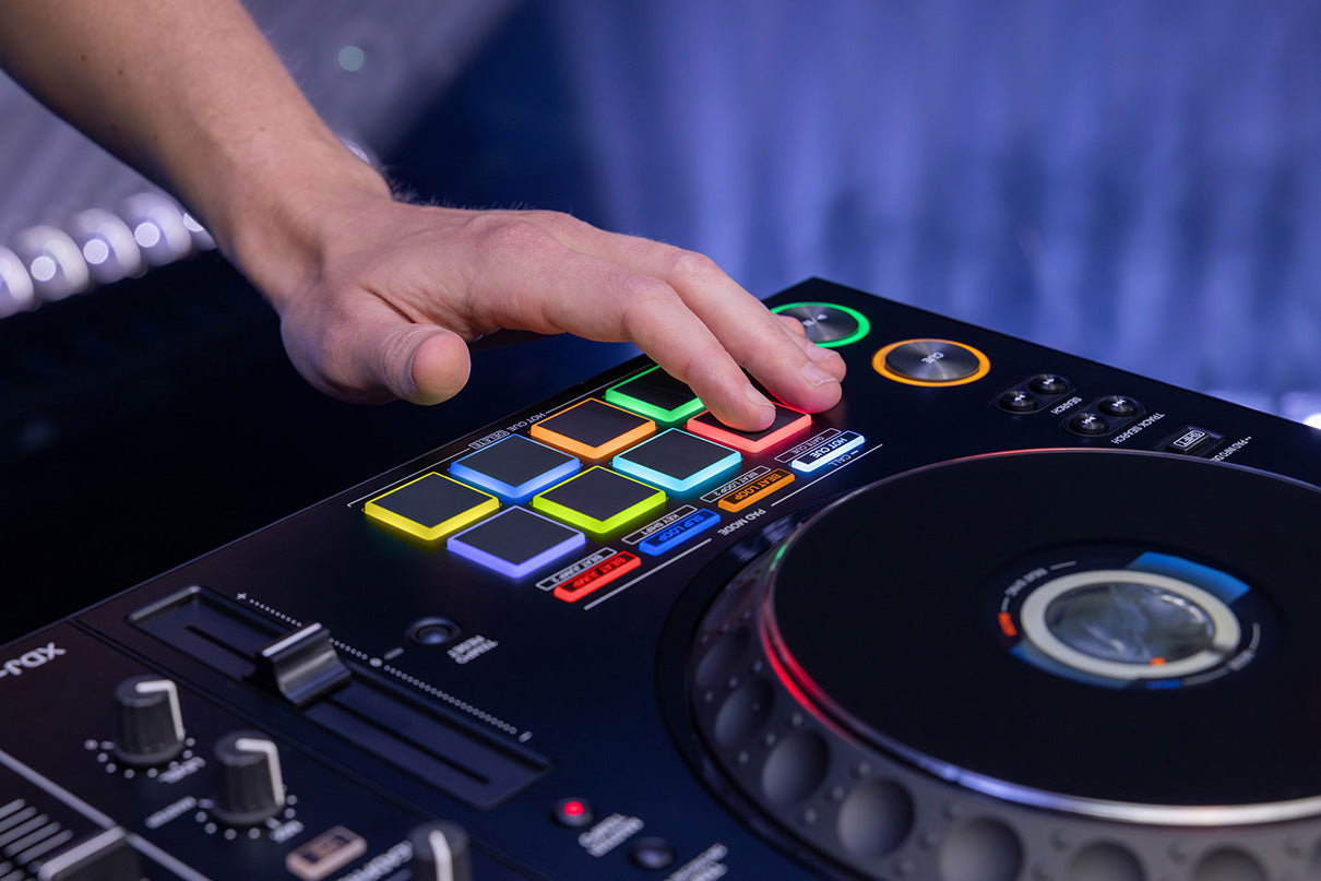 AlphaTheta XDJ-AZ DJ media player setup with DJ headphones and equipment on a lifestyle table scene.