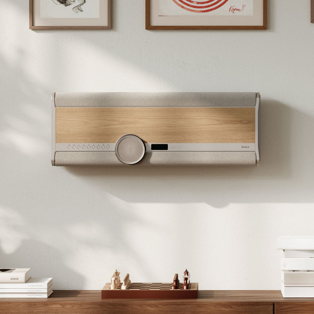 Dali Vega wall-mounted in a living room, Natural Oak finish