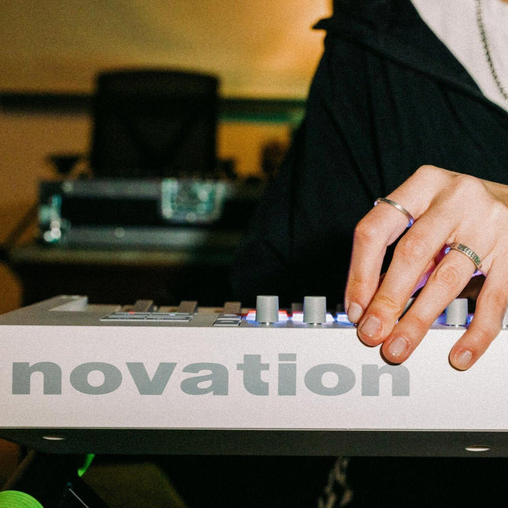 Novation Launchkey 49 MK4 MIDI keyboard with white finish, featuring keys, knobs, and pads for music production.