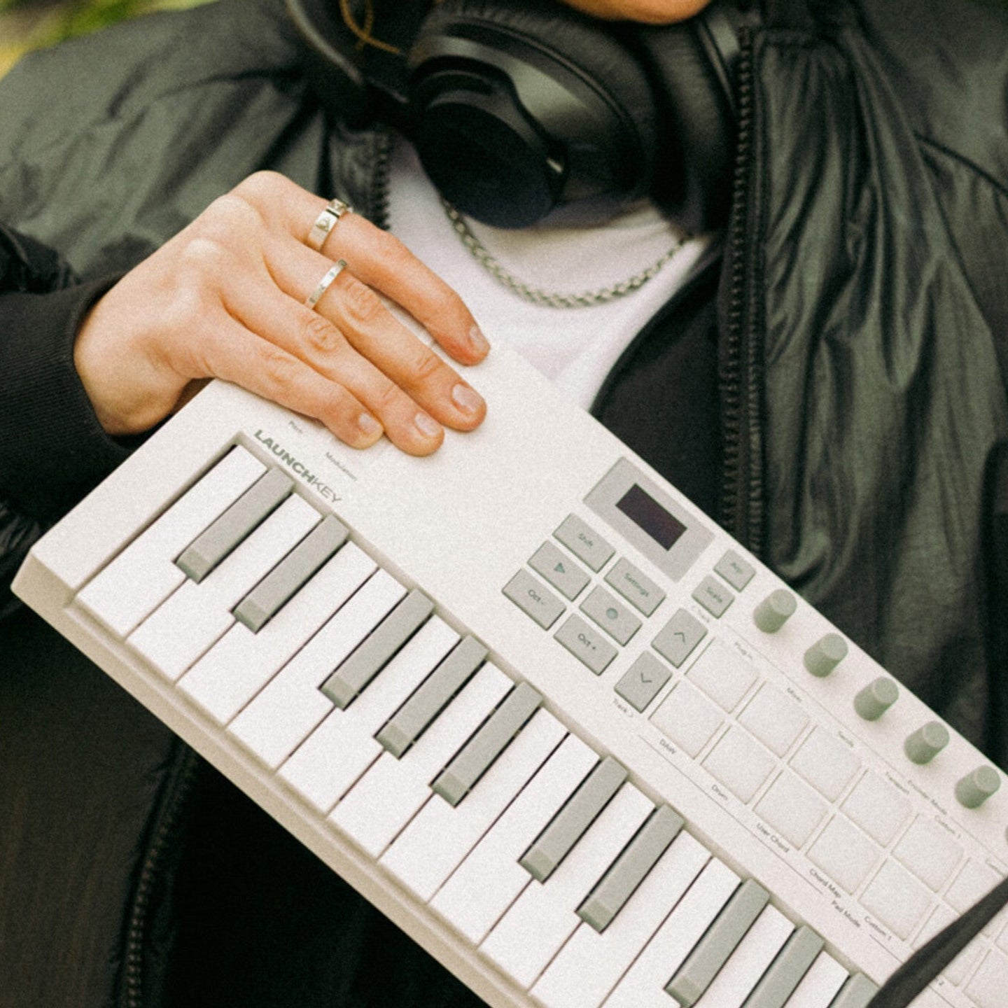 Novation Launchkey Mini 37 MK4 MIDI keyboard with white case, compact design, and control knobs for music production.