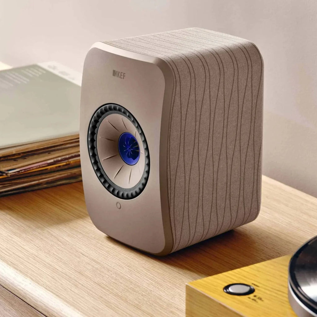 KEF LSX II active bookshelf speakers shown in a modern home setting with sleek design and advanced audio features.