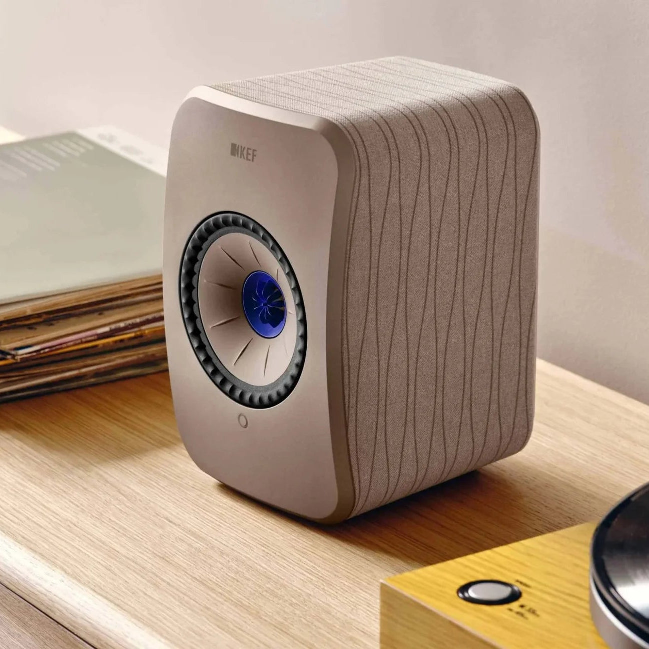 KEF LSX II active bookshelf speakers shown in a modern home setting with sleek design and advanced audio features.