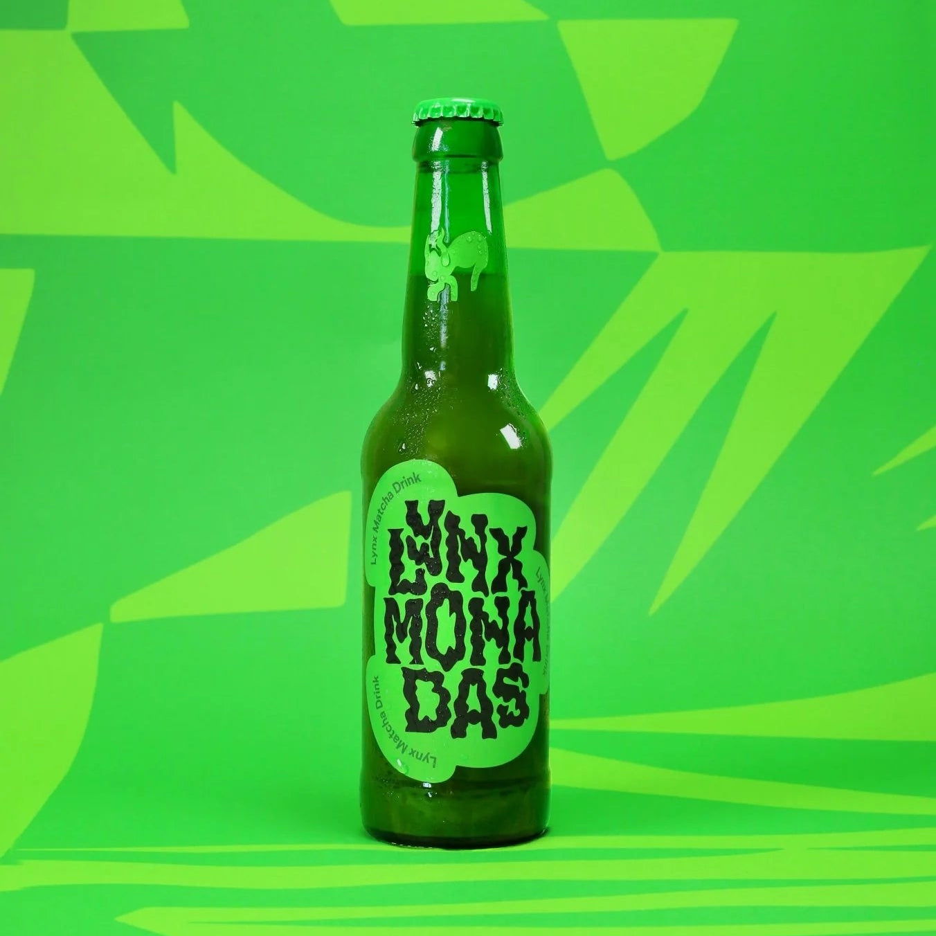 Green bottle with 'YNX MONADAS' label on a green background