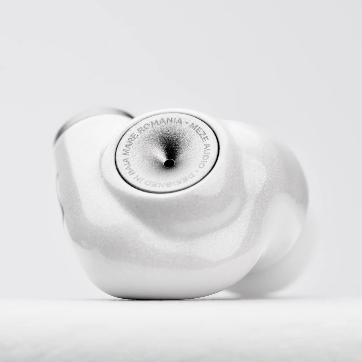 Meze Audio Alba in-ear headphones with black earbuds and silver accents, shown from a close-up angle.