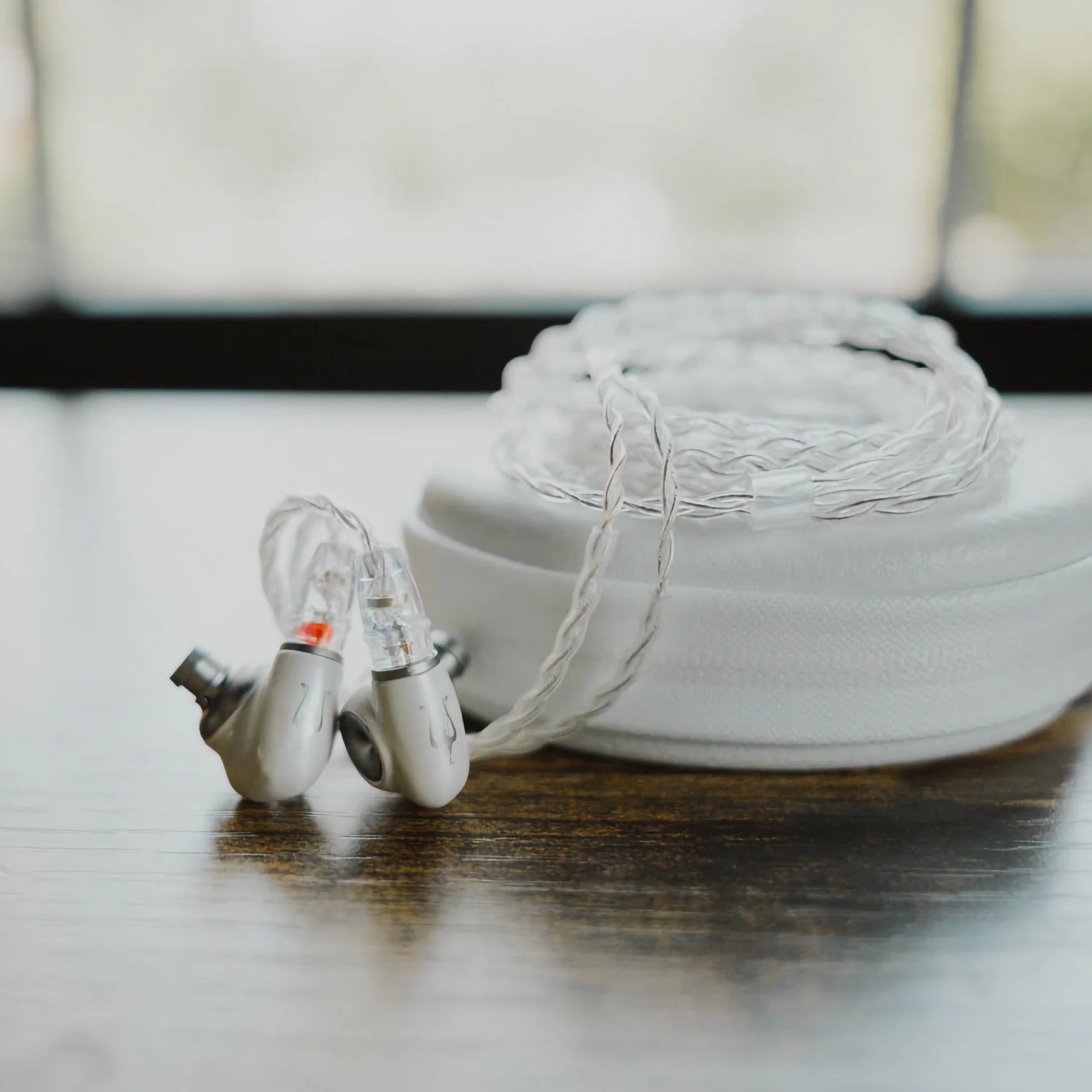 Meze Audio Alba in-ear headphones with sleek black earbuds and braided cable, showcasing premium design and comfortable fit.