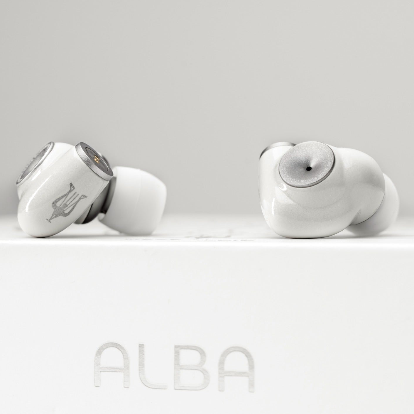 Meze Audio Alba in-ear headphones with sleek black design and silver accents, displayed on a white background.