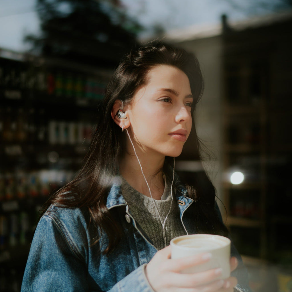 Meze Audio Alba in-ear headphones with sleek black design, featuring ergonomic earbuds and audio cables.