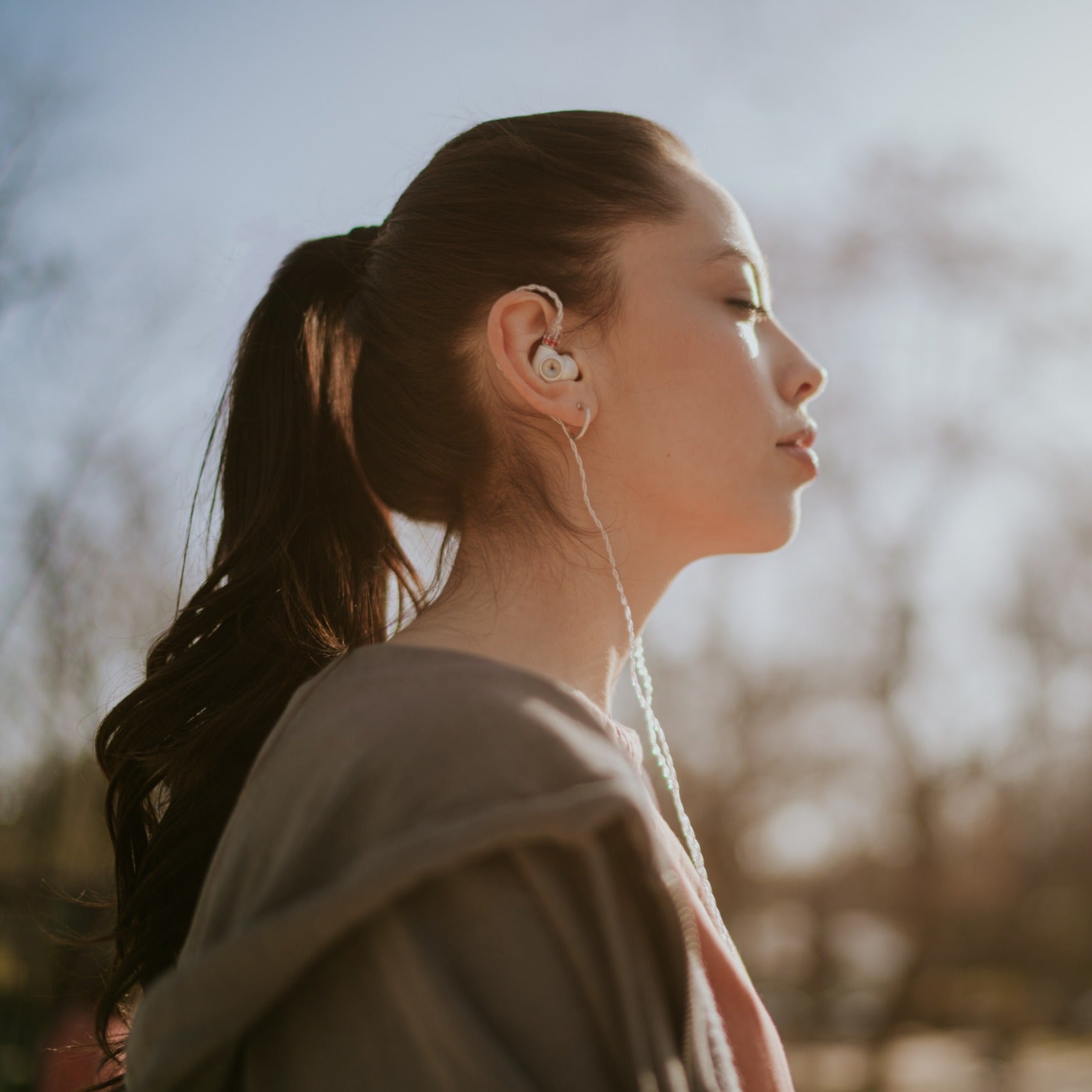 Meze Audio Alba in-ear headphones with black earbuds and braided cable, showcasing sleek design and premium build quality.