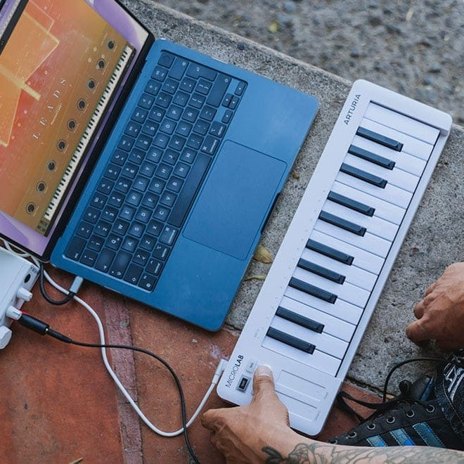 Arturia MicroLab MK3 MIDI keyboard with compact design, featuring black keys, control knobs, and connectivity ports.