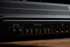 Moog Muse synthesizer with black background, showcasing its knobs and interface in a close-up shot.