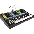 Moog Grandmother synthesizer with vintage design, featuring knobs, patch cables, and keyboard for analog sound creation.