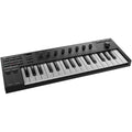 Native Instruments Komplete Kontrol M32 MIDI keyboard with black keys, knobs, and controls on a sleek surface.