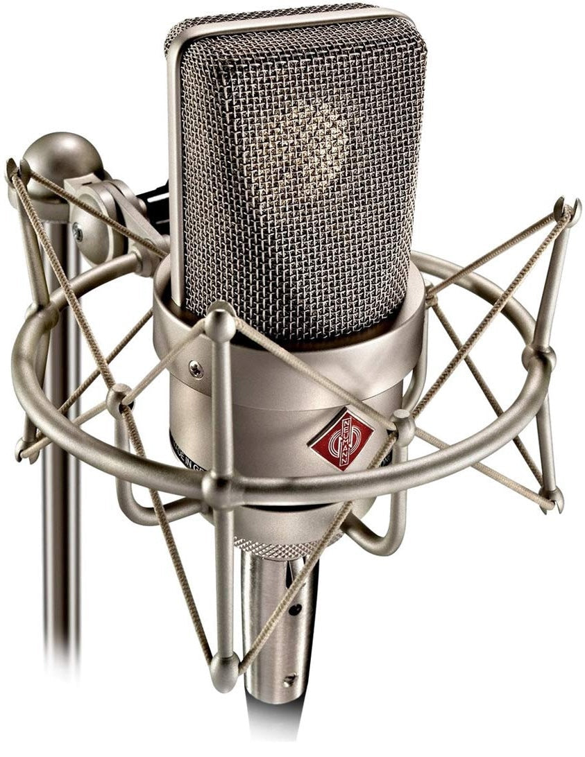 Neumann TLM 103 condenser microphone set with microphone, shock mount, and accessories for studio recording.