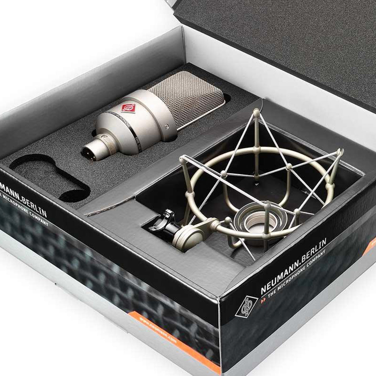 Neumann TLM 103 condenser microphone in silver carton box, professional studio microphone for high-quality audio recording.
