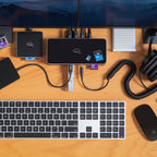 OWC Thunderbolt 5 Dock, top-down desk setup with keyboard, headphones and memory cards