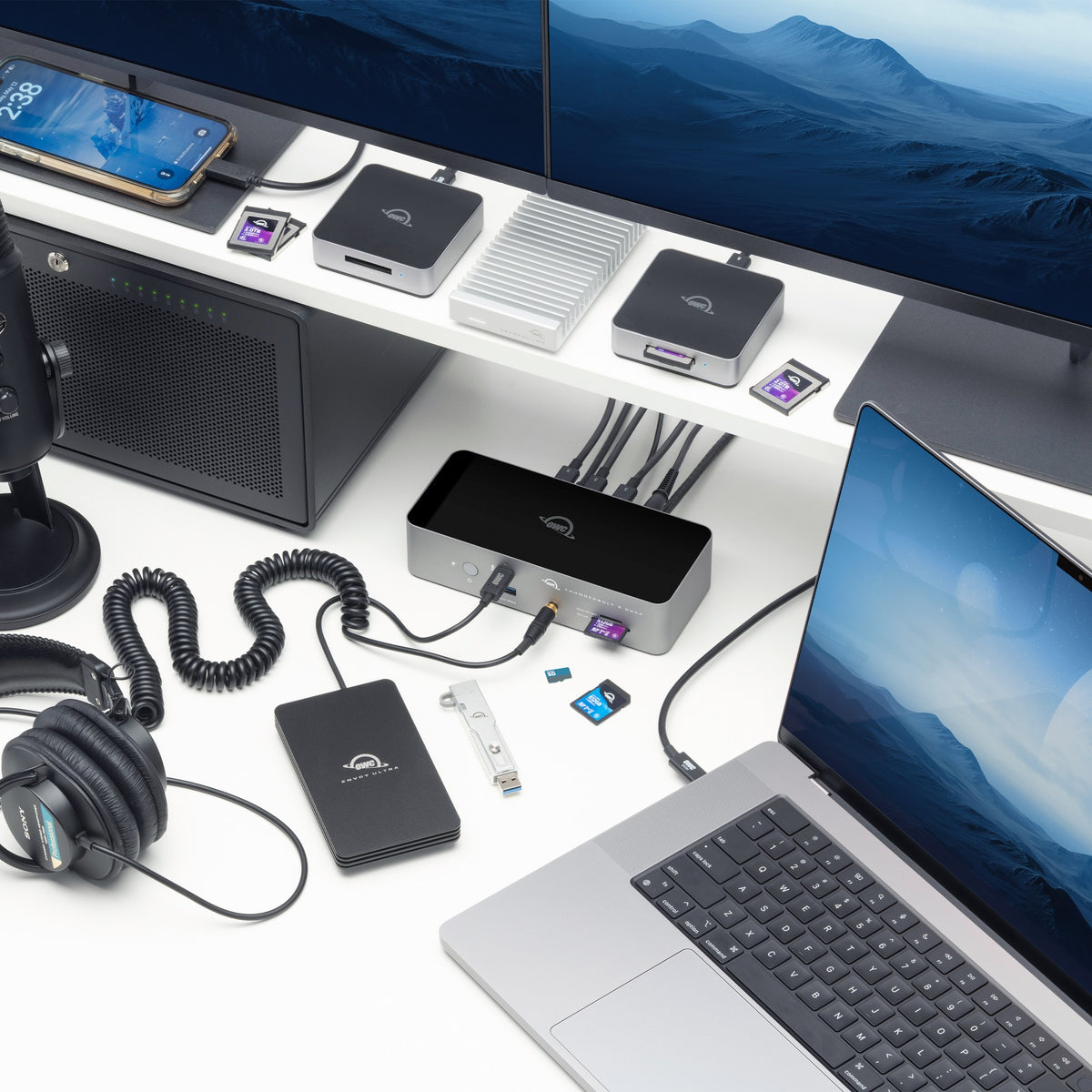 OWC Thunderbolt 5 Dock, on a creator desk with MacBook Pro, displays and OWC storage