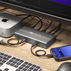 OWC USB4 Hub, close-up on desk with connected SSD and phone